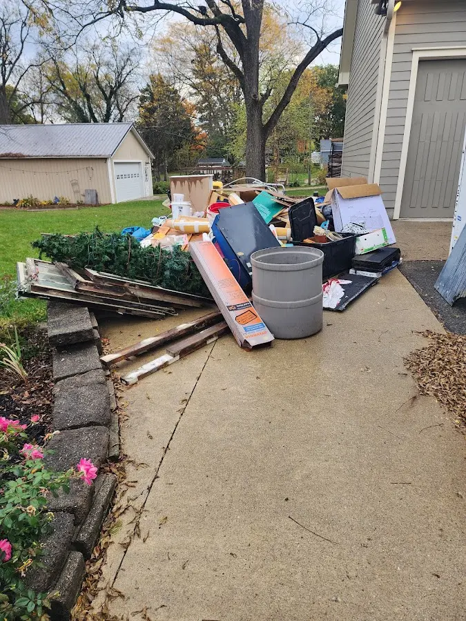 Dumpster being loaded with debris for Estate Cleanout Dumpster Rental in Soda Springs